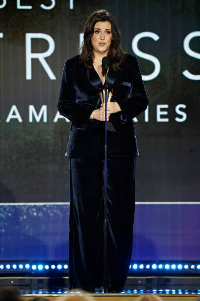 Melanie Lynskey in custom HOUGHTON navy blue velvet tuxedo winning a critics choice award for lead actress in Yellow Jackets